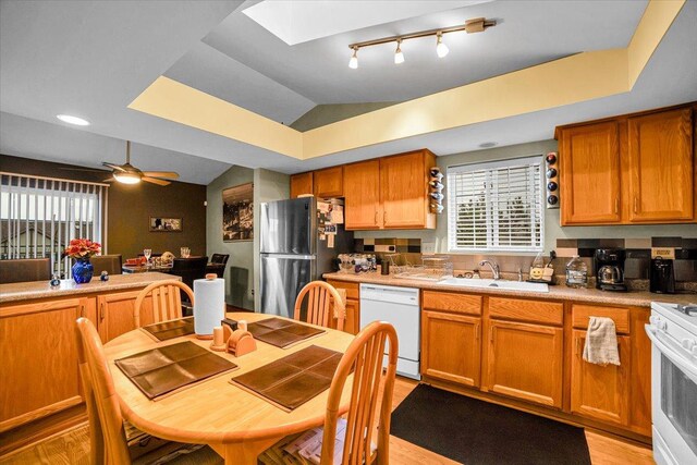 6719 W White Tailed Ln Unit 3E, Tinley Park, IL 60477 - kitchen featuring white appliances, a sink, a skylight, light countertops, and light wood finished floors