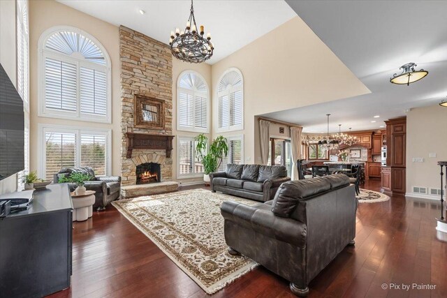 11 Moate Ln, Barrington Hills, IL 60010 - living area featuring a chandelier, a towering ceiling, a fireplace, dark wood-type flooring, and recessed lighting