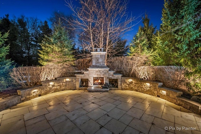 11 Moate Ln, Barrington Hills, IL 60010 - patio at night featuring an outdoor stone fireplace and a patio