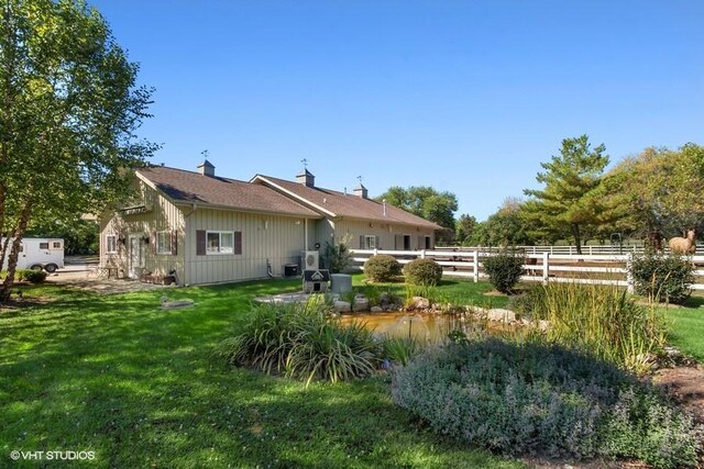 11 Moate Ln, Barrington Hills, IL 60010 - back of house with board and batten siding and a chimney