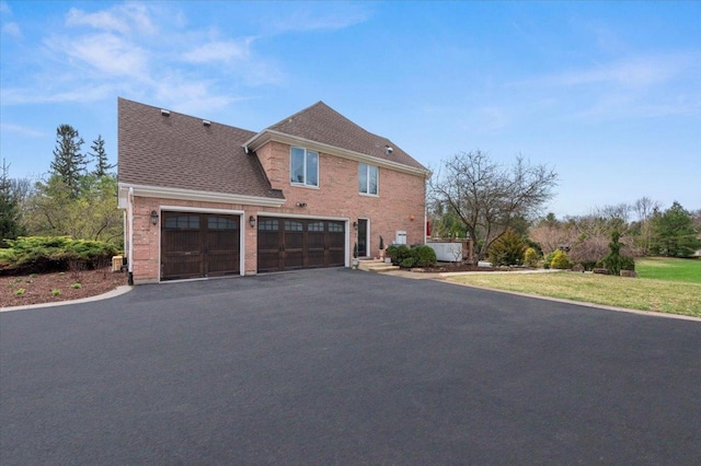 11 Moate Ln, Barrington Hills, IL 60010 - view of home's exterior featuring driveway, a garage, brick siding, and a shingled roof