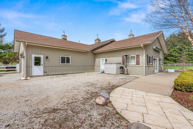 11 Moate Ln, Barrington Hills, IL 60010 - view of front facade with a chimney, driveway, and roof with shingles