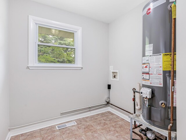 3411 Caton Farm Rd, Joliet, IL 60431 - laundry area featuring water heater, hookup for an electric dryer, baseboards, hookup for a washing machine, and tile patterned flooring