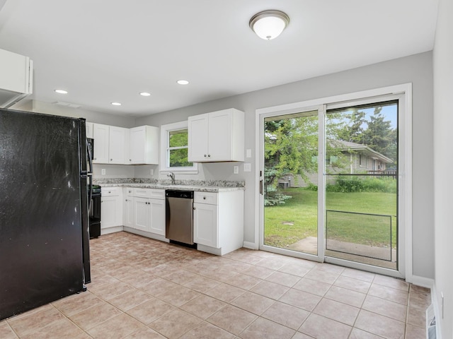 3411 Caton Farm Rd, Joliet, IL 60431 - kitchen featuring stainless steel dishwasher, freestanding refrigerator, light stone counters, white cabinets, and light tile patterned floors