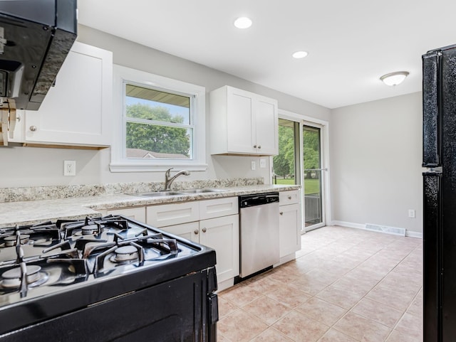 3411 Caton Farm Rd, Joliet, IL 60431 - kitchen featuring stainless steel dishwasher, black gas stove, a sink, light countertops, and white cabinetry