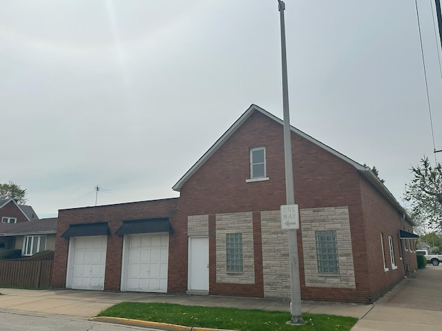 347 156th St, Calumet City, IL 60409 - view of front of property featuring brick siding, driveway, a garage, and stone siding
