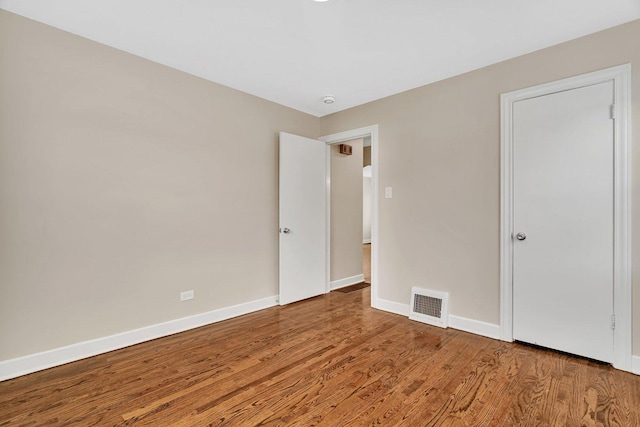 5200 S Newcastle Ave, Chicago, IL 60638 - unfurnished bedroom with wood finished floors and baseboards