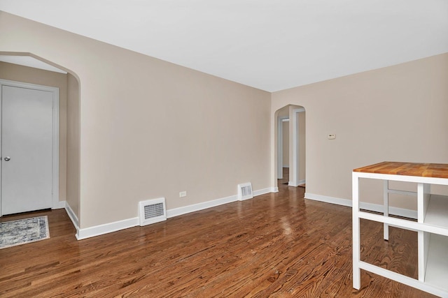 5200 S Newcastle Ave, Chicago, IL 60638 - spare room featuring arched walkways, wood finished floors, and baseboards