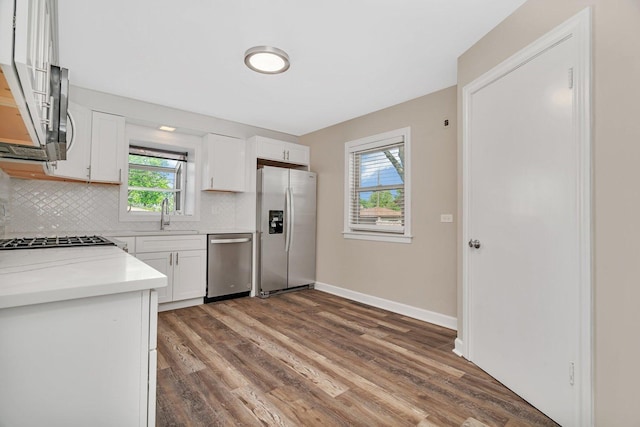 5200 S Newcastle Ave, Chicago, IL 60638 - kitchen featuring stainless steel appliances, wood finished floors, backsplash, and plenty of natural light