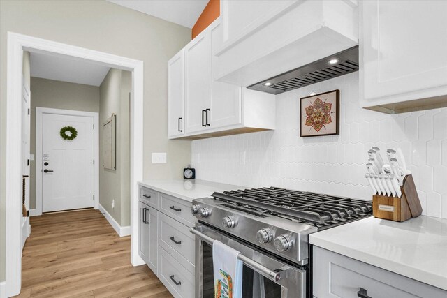 1721 S Stone Creek Blvd, Urbana, IL 61802 - kitchen with premium range hood, gas range, backsplash, light wood finished floors, and light countertops
