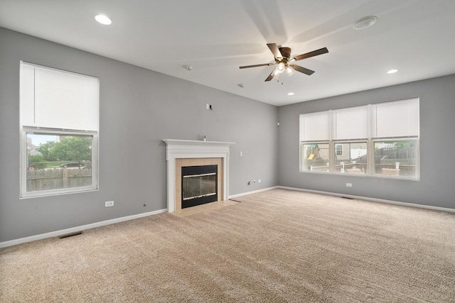 8013 Shady Oak Rd, Joliet, IL 60431 - unfurnished living room with a ceiling fan, carpet, a tiled fireplace, baseboards, and recessed lighting
