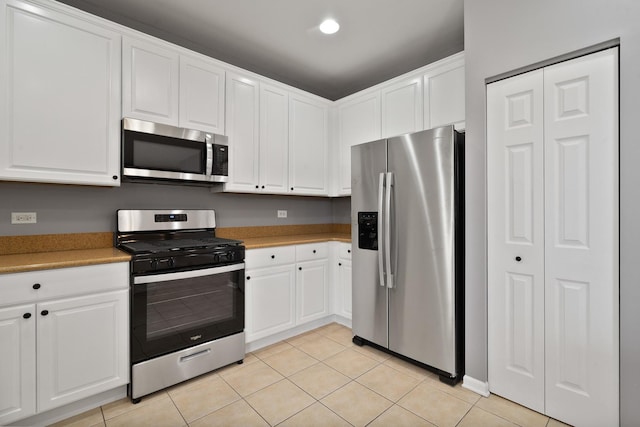8013 Shady Oak Rd, Joliet, IL 60431 - kitchen with stainless steel appliances, white cabinetry, light tile patterned floors, and light countertops