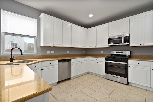 8013 Shady Oak Rd, Joliet, IL 60431 - kitchen featuring stainless steel appliances, a sink, light tile patterned floors, white cabinets, and recessed lighting
