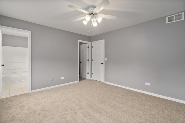 8013 Shady Oak Rd, Joliet, IL 60431 - unfurnished bedroom with carpet floors, baseboards, connected bathroom, and a ceiling fan