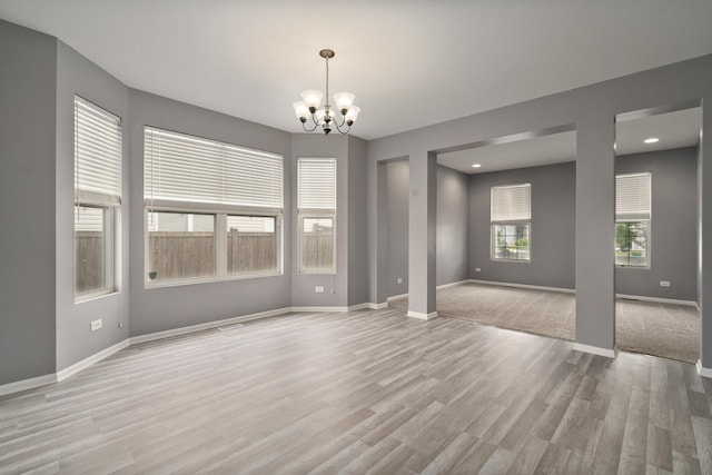 8013 Shady Oak Rd, Joliet, IL 60431 - spare room featuring a chandelier, light wood-type flooring, baseboards, and recessed lighting
