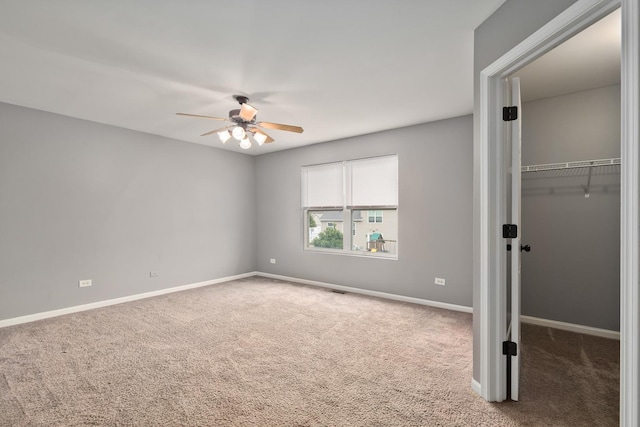 8013 Shady Oak Rd, Joliet, IL 60431 - unfurnished bedroom featuring carpet, a walk in closet, baseboards, a closet, and a ceiling fan