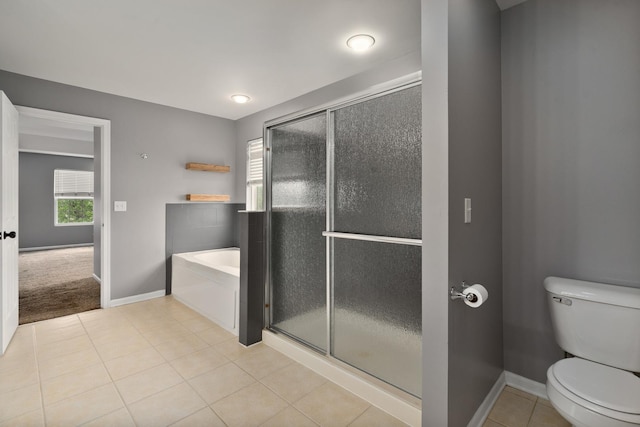 8013 Shady Oak Rd, Joliet, IL 60431 - bathroom featuring a bath, toilet, baseboards, a shower with door, and tile patterned flooring