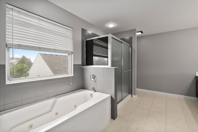 8013 Shady Oak Rd, Joliet, IL 60431 - bathroom featuring a jetted tub, a stall shower, tile patterned floors, and baseboards
