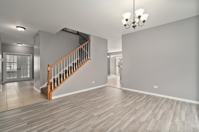 8013 Shady Oak Rd, Joliet, IL 60431 - unfurnished living room featuring stairs, wood finished floors, a chandelier, and baseboards