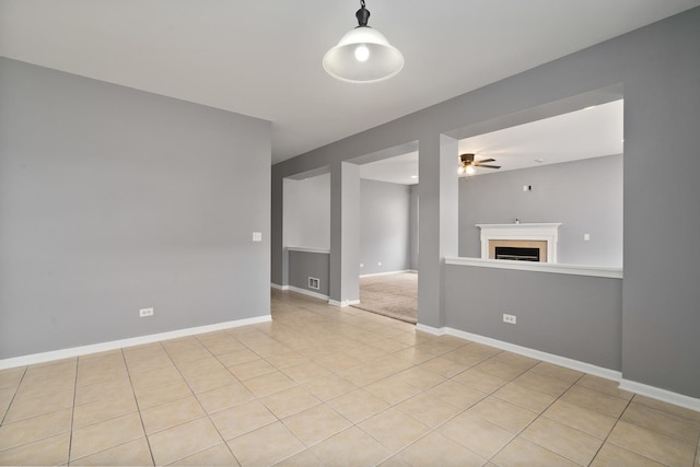 8013 Shady Oak Rd, Joliet, IL 60431 - spare room featuring ceiling fan, a fireplace, light tile patterned flooring, and baseboards