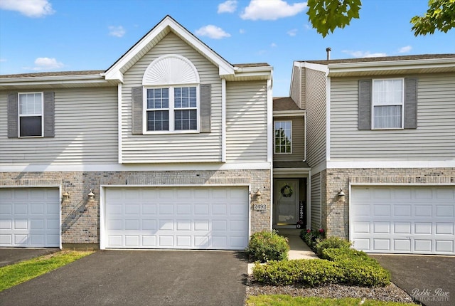 2492 Amber Ln, Elgin, IL 60123 - townhome / multi-family property with brick siding, asphalt driveway, and an attached garage