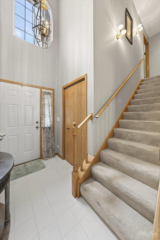 2492 Amber Ln, Elgin, IL 60123 - foyer entrance with a towering ceiling, stairs, and a chandelier