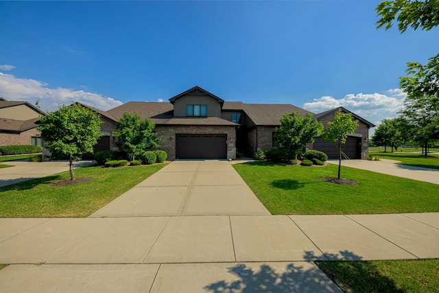 10749 Revere Cir, Mokena, IL 60448 - view of front of home featuring a front yard, concrete driveway, a garage, and brick siding