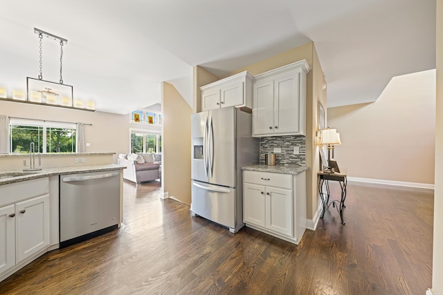 10749 Revere Cir, Mokena, IL 60448 - kitchen featuring appliances with stainless steel finishes, tasteful backsplash, dark wood-type flooring, white cabinetry, and light stone countertops