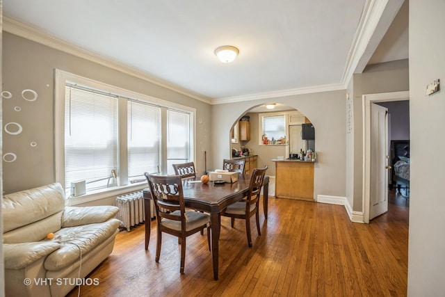 22 S Austin Blvd, Oak Park, IL 60302 - dining room featuring radiator heating unit, hardwood / wood-style floors, crown molding, and arched walkways
