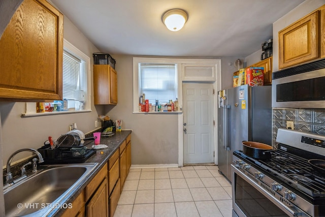 22 S Austin Blvd, Oak Park, IL 60302 - kitchen with appliances with stainless steel finishes, dark countertops, brown cabinetry, and light tile patterned floors