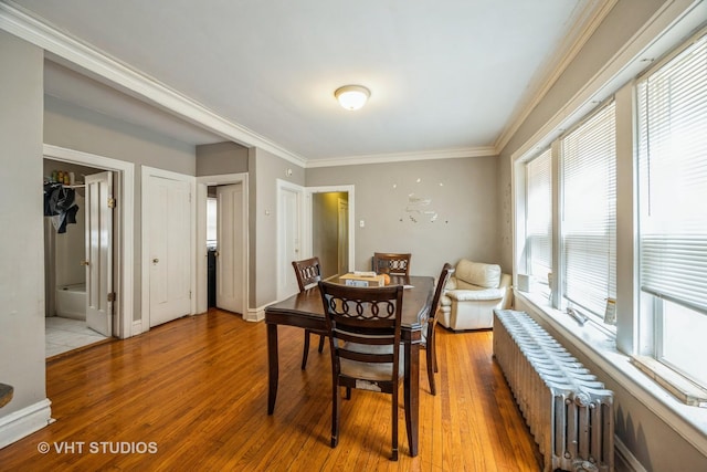 22 S Austin Blvd, Oak Park, IL 60302 - dining space featuring radiator heating unit, ornamental molding, and light wood finished floors