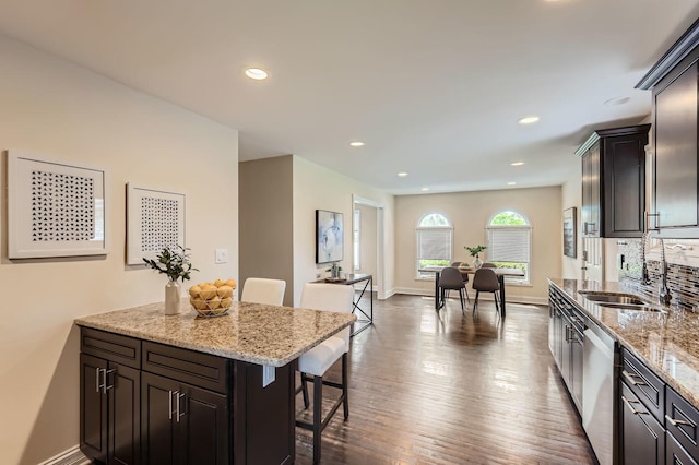 406 Lauder Ln, Inverness, IL 60067 - kitchen featuring dishwasher, a kitchen bar, a sink, light stone counters, and recessed lighting