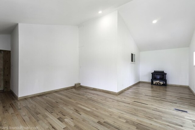 23314 W Liberty Ave, Lake Villa, IL 60046 - additional living space with a wood stove, light wood-style floors, lofted ceiling, baseboards, and recessed lighting