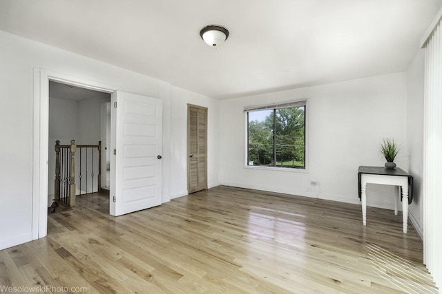 23314 W Liberty Ave, Lake Villa, IL 60046 - unfurnished bedroom featuring light wood-style floors, a closet, and baseboards