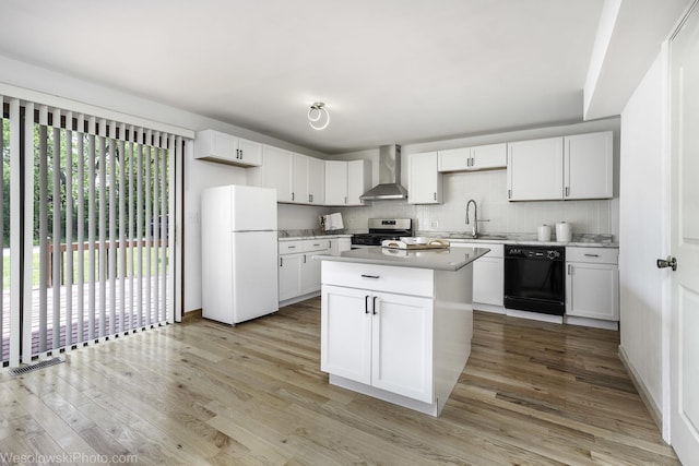 23314 W Liberty Ave, Lake Villa, IL 60046 - kitchen featuring freestanding refrigerator, dishwasher, stainless steel gas stove, wall chimney range hood, and light wood-style flooring