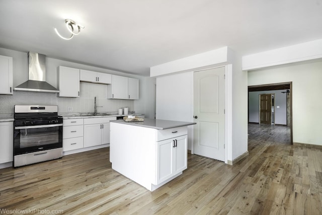 23314 W Liberty Ave, Lake Villa, IL 60046 - kitchen with wall chimney range hood, stainless steel gas range oven, a sink, and light wood finished floors