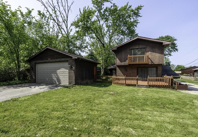 23314 W Liberty Ave, Lake Villa, IL 60046 - view of front of property with brick siding, a front lawn, a detached garage, a deck, and an outdoor structure