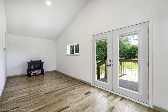 23314 W Liberty Ave, Lake Villa, IL 60046 - doorway with a wood stove, french doors, light wood-type flooring, baseboards, and high vaulted ceiling