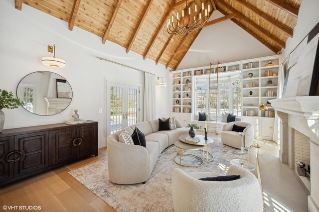 111 Oxford Rd, Kenilworth, IL 60043 - living area with wood ceiling with exposed beams, high vaulted ceiling, wood finished floors, french doors, and a chandelier