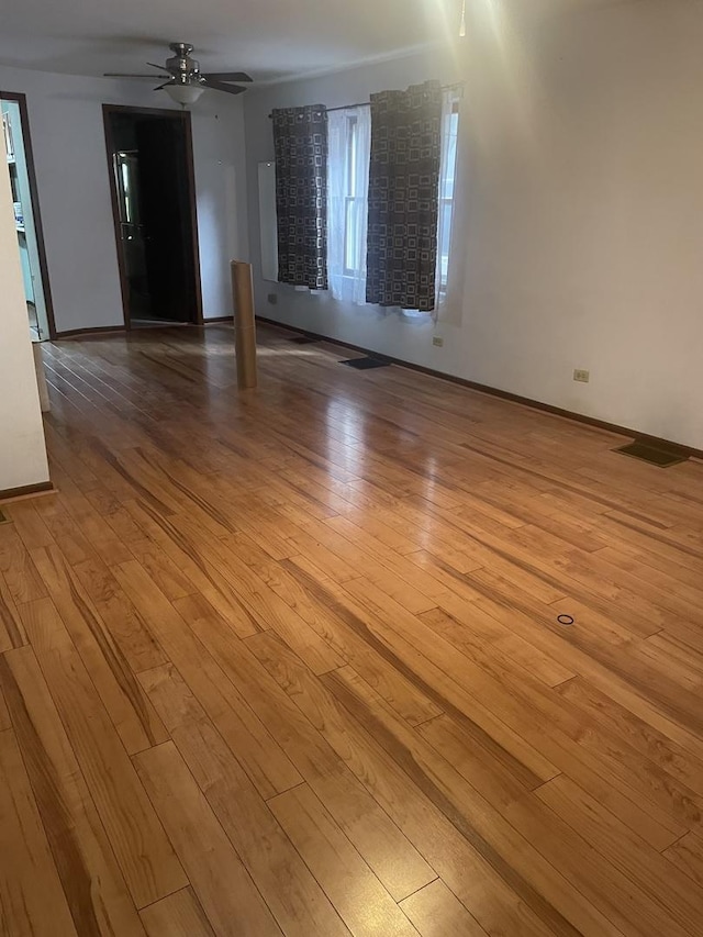 4121 N Moody Ave, Chicago, IL 60634 - unfurnished room with light wood-style flooring, a ceiling fan, and baseboards
