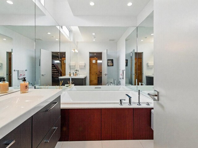 7415 W Main St, Niles, IL 60714 - bathroom featuring two vanities, recessed lighting, a garden tub, toilet, and tile patterned flooring