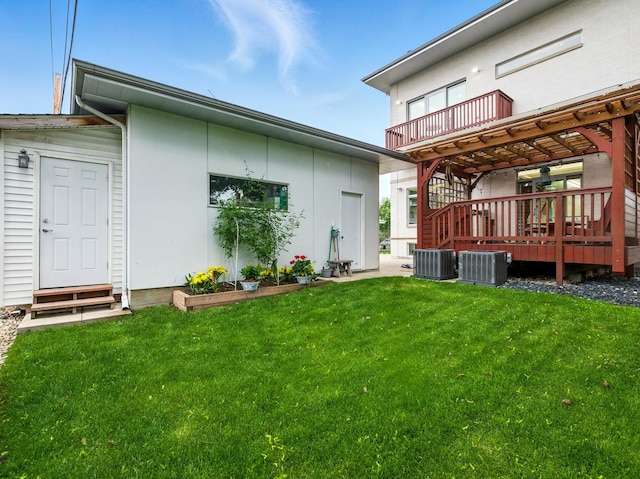 7415 W Main St, Niles, IL 60714 - back of house with a yard, cooling unit, stucco siding, and a wooden deck