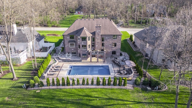 14151 131st St, Lemont, IL 60439 - rear view of property featuring a hot tub, brick siding, a patio, a chimney, and a balcony