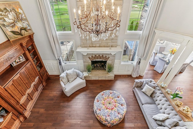 14151 131st St, Lemont, IL 60439 - living area with hardwood / wood-style floors, a chandelier, wainscoting, a high ceiling, and a fireplace with raised hearth