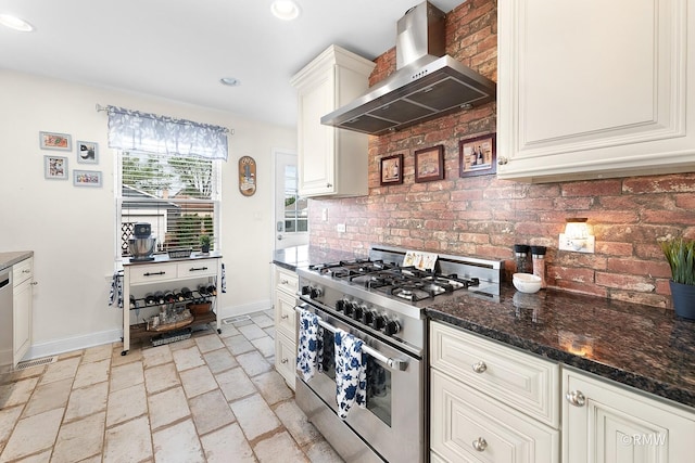 735 S Spring Rd, Elmhurst, IL 60126 - kitchen featuring high end range, wall chimney exhaust hood, baseboards, backsplash, and stone tile flooring