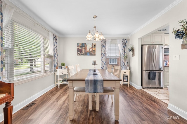 735 S Spring Rd, Elmhurst, IL 60126 - dining space with a chandelier, wood finished floors, baseboards, and crown molding