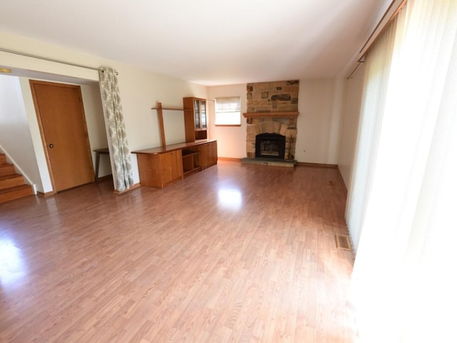 1740 Somerfield Ln, Crystal Lake, IL 60014 - unfurnished living room with light wood-style floors, a fireplace, and stairs