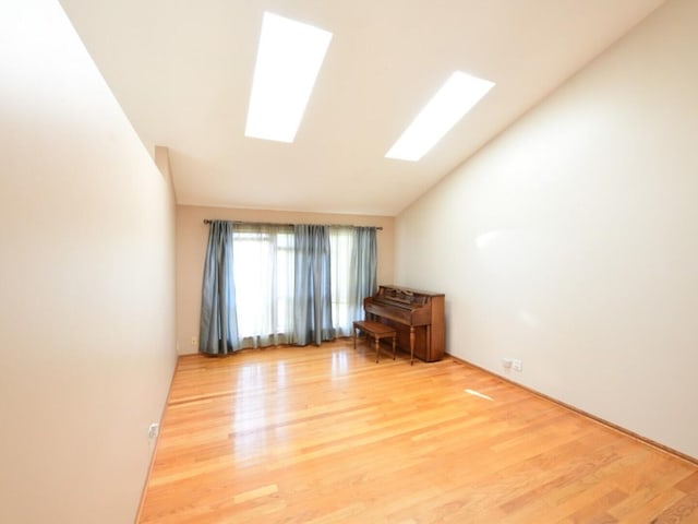 1740 Somerfield Ln, Crystal Lake, IL 60014 - spare room with lofted ceiling, wood finished floors, and a skylight