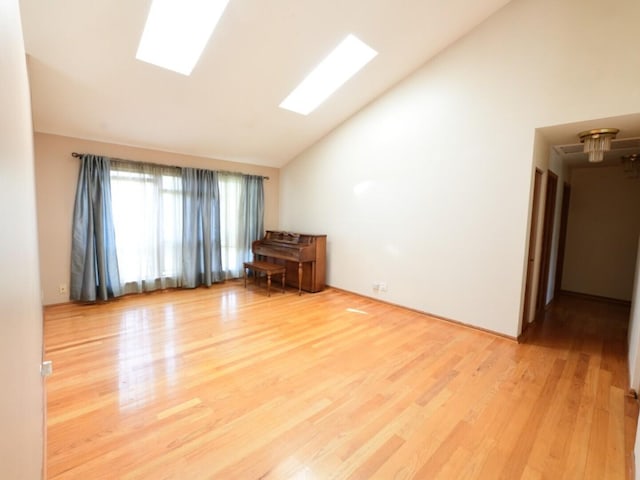 1740 Somerfield Ln, Crystal Lake, IL 60014 - spare room featuring wood finished floors, high vaulted ceiling, and a skylight