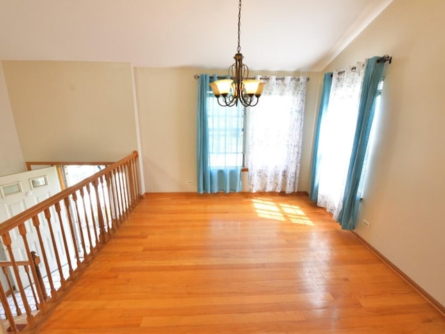 1740 Somerfield Ln, Crystal Lake, IL 60014 - unfurnished dining area with a chandelier, light wood-type flooring, and vaulted ceiling